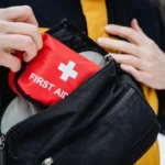 person is currently holding a small first aid kit