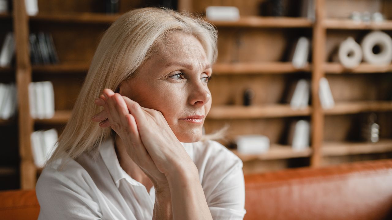middle aged mature woman relaxing on the couch sofa