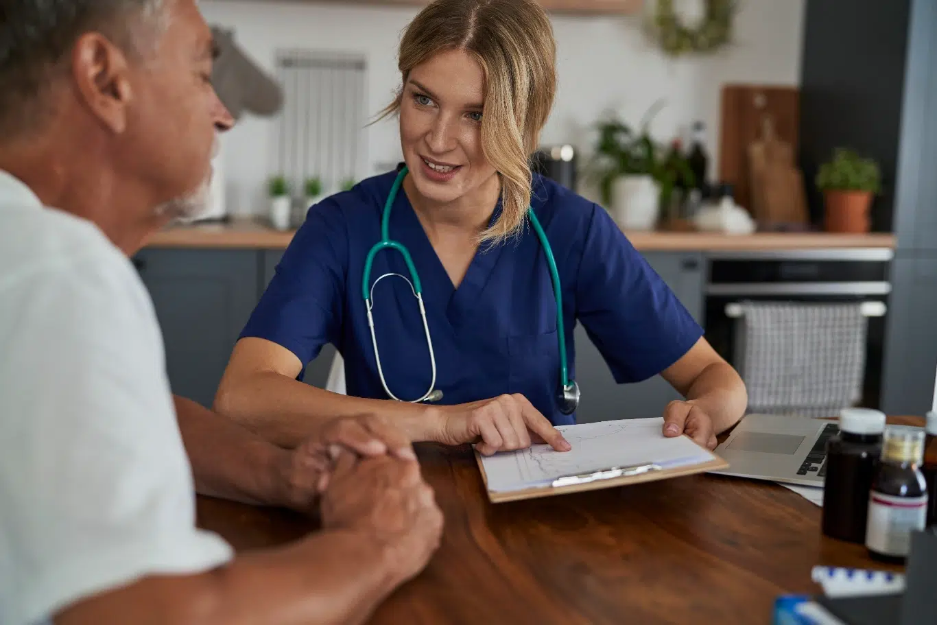 Caucasian female doctor at the home visit Senior meets with healthcare professional for consultation at home